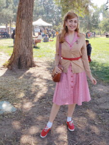 Girl in red gingham dress and cardigan sweater