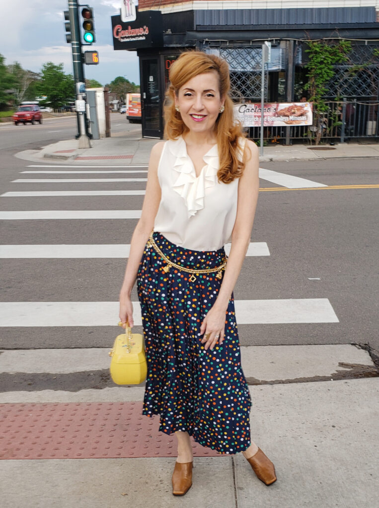 1970s inspired look with ruffle top and pleated polka dot midi skirt